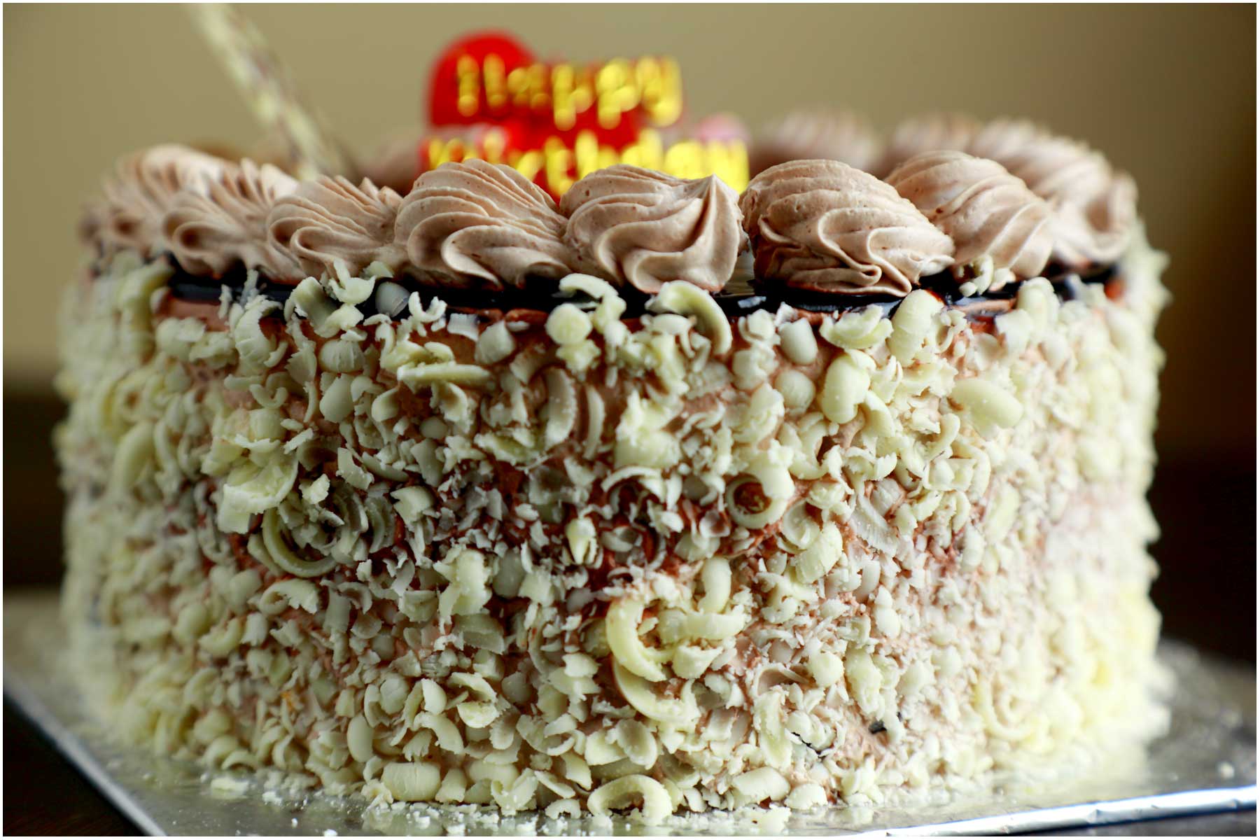 a cake with whipped cream and chocolate toppings