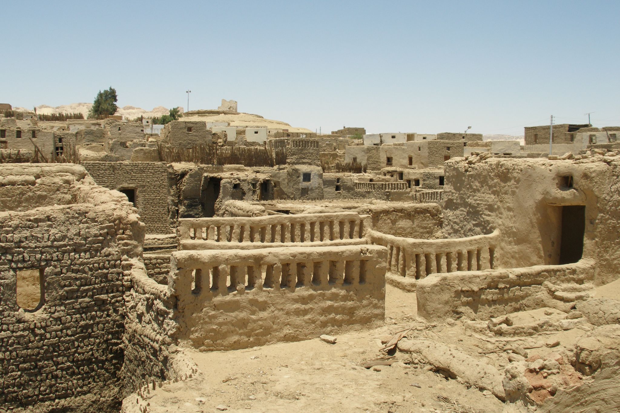 some buildings in an arid village with many windows