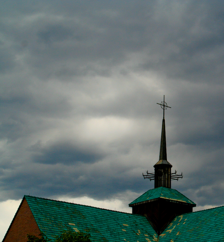 a steeple of a building with a cross on top