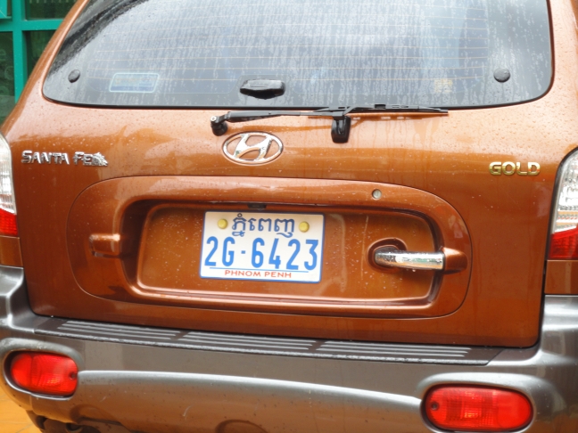 the back of a car is brown with a license plate