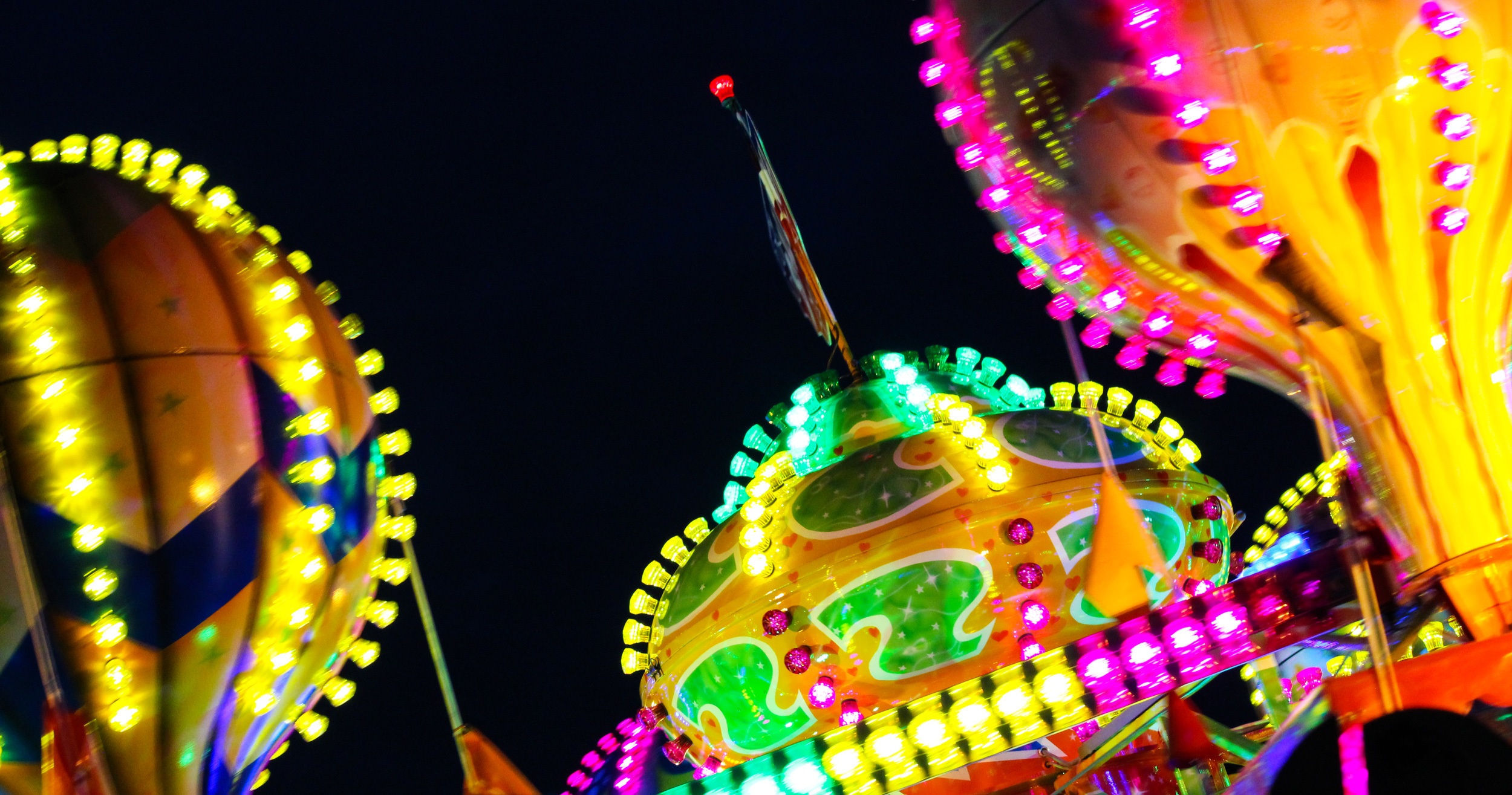 carnival floats and lights on a nighttime sky