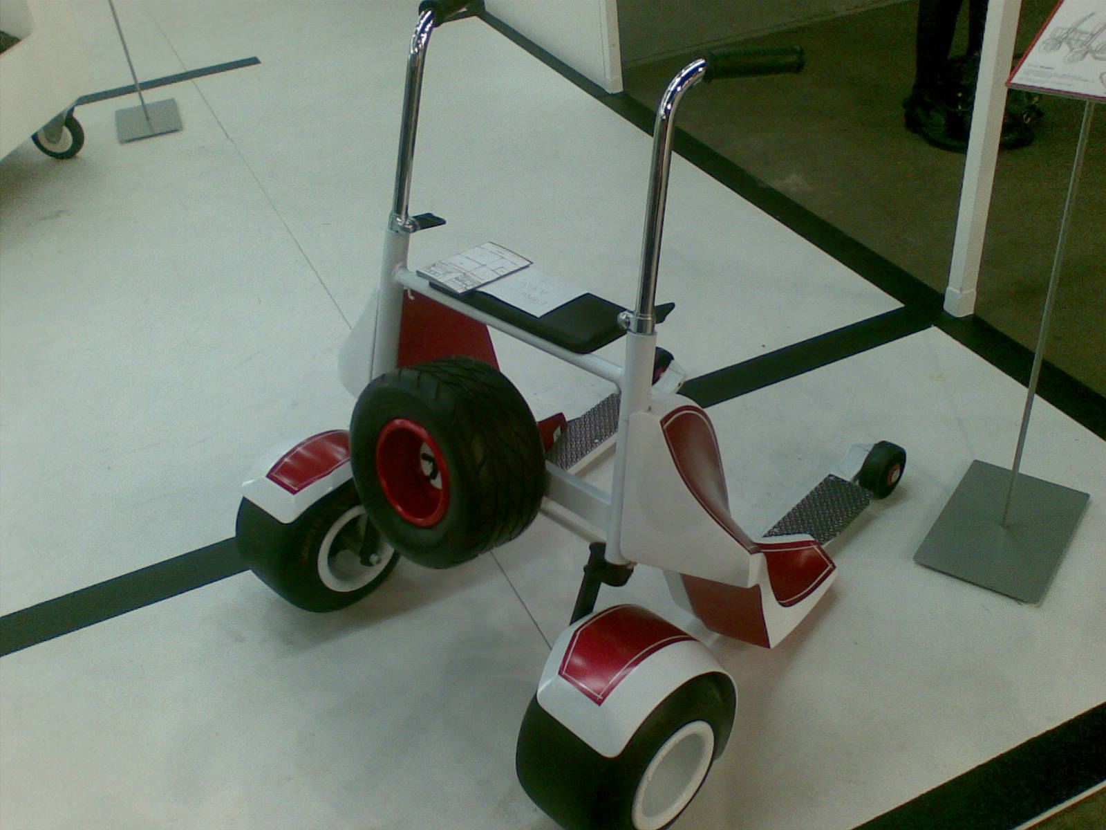 a motorized scooter in motion on display on a floor