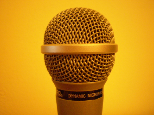 the microphone is brown in color with white letters