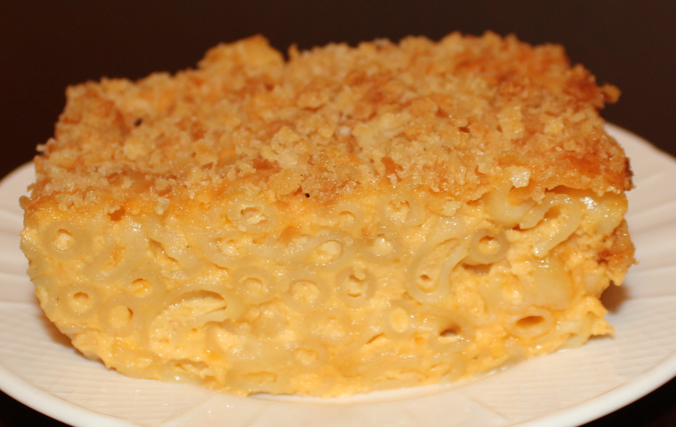a white plate topped with macaroni and cheese cake