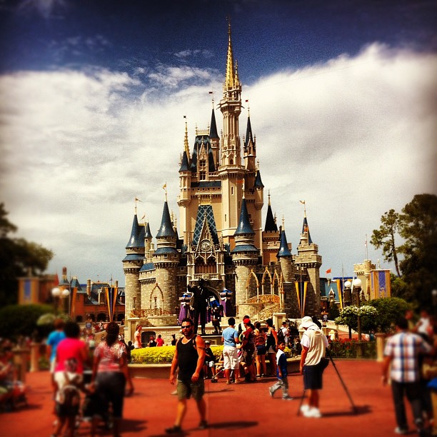 a group of people standing next to a castle