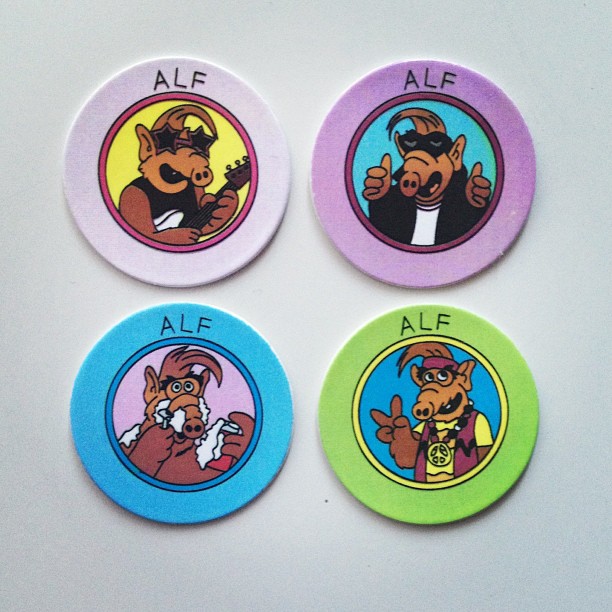 four round stickers with a graphic of three dogs on each one