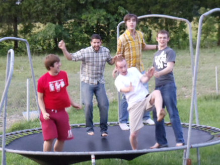 the young people are trying to play a game on a trampoline