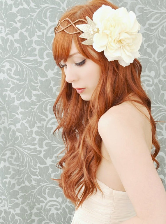 a young woman with long red hair wears an art nouveau styled flower hair piece