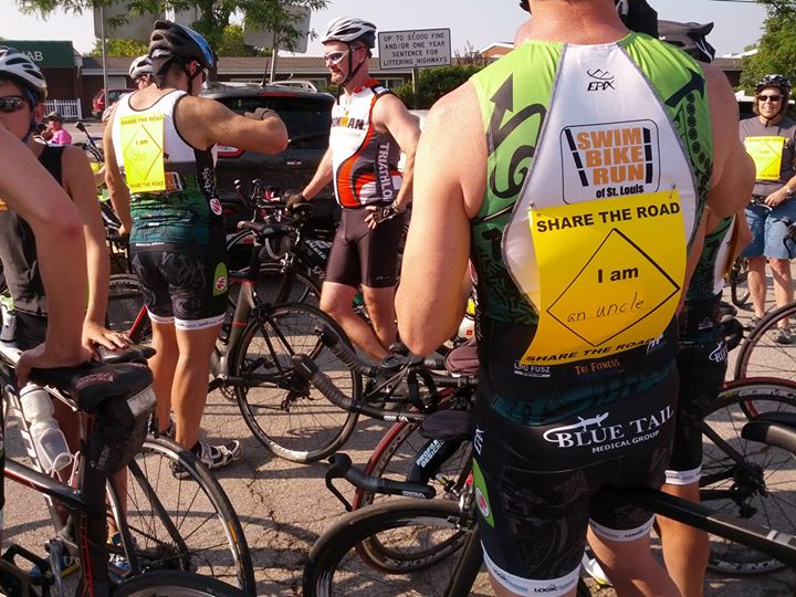 a group of bicyclists are gathered around while standing in line