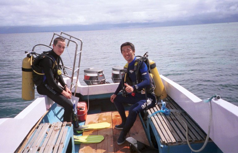two men who are on a boat getting ready to go into the water