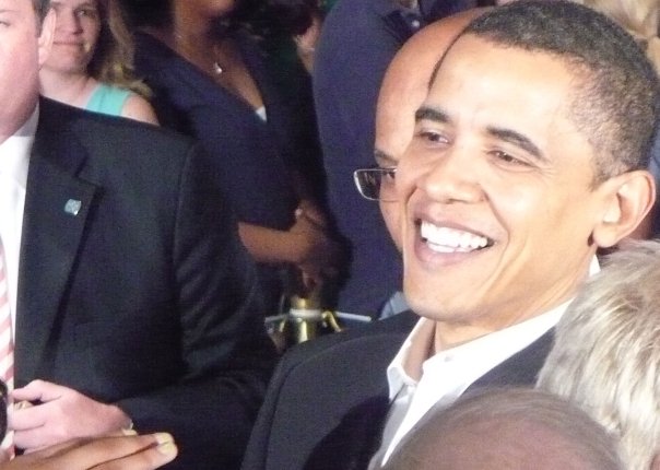 president obama smiling for the camera at a gathering
