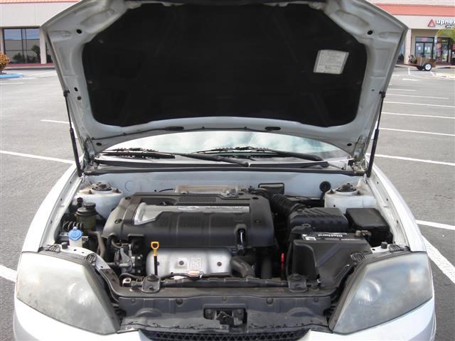 an open hatchback trunk of a car with the hood on