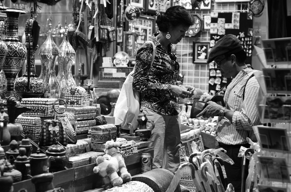 two people standing at a table inside of a store