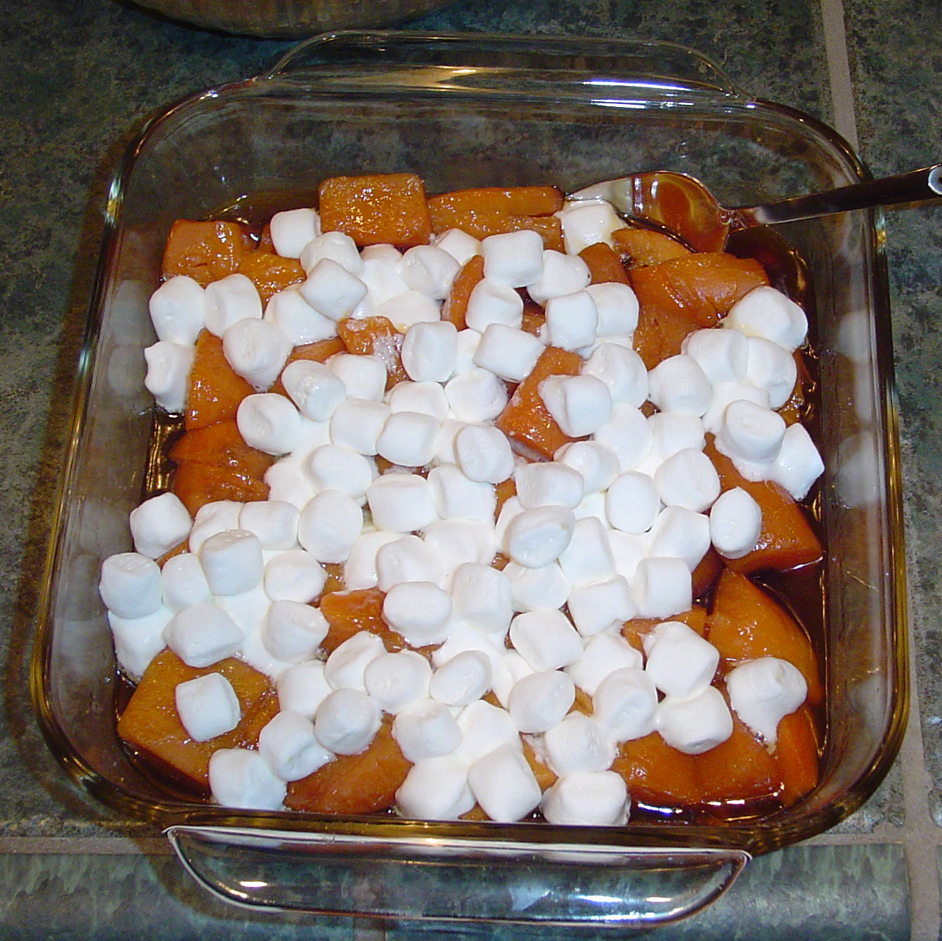 a glass dish full of marshmallows and orange slices