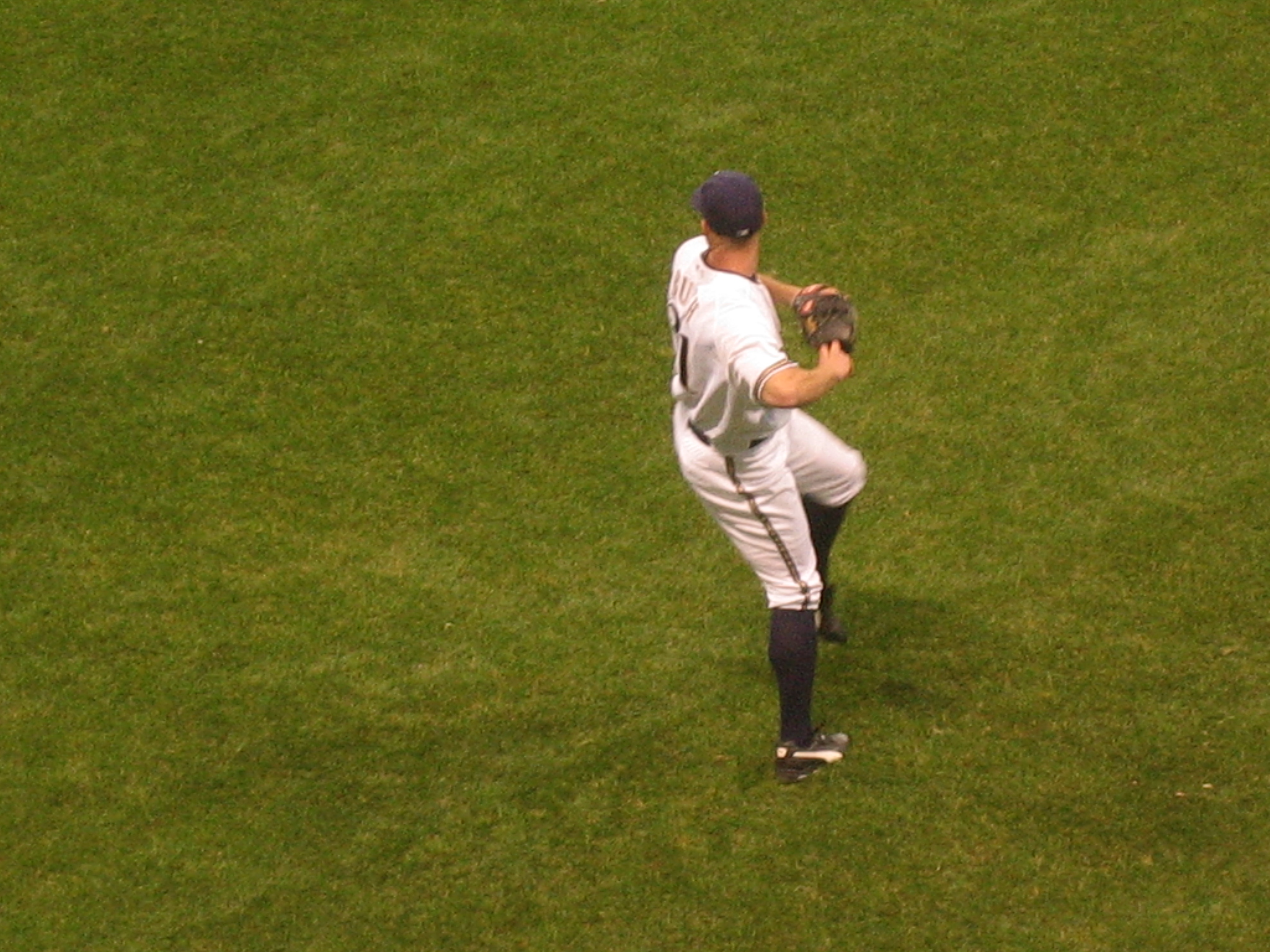 a baseball player is standing in the outfield of the stadium
