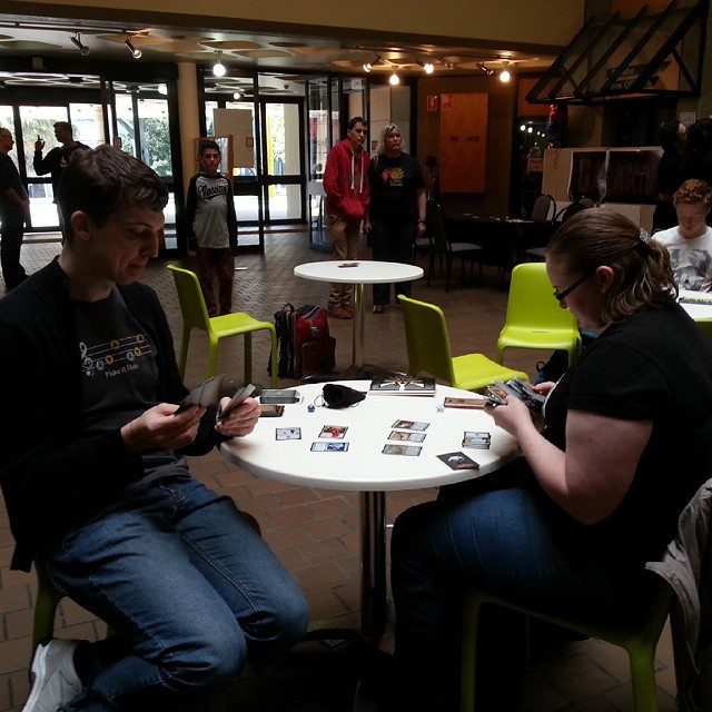 two people at a table using cell phones