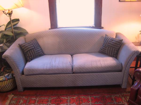 this is a couch sitting in front of a large window