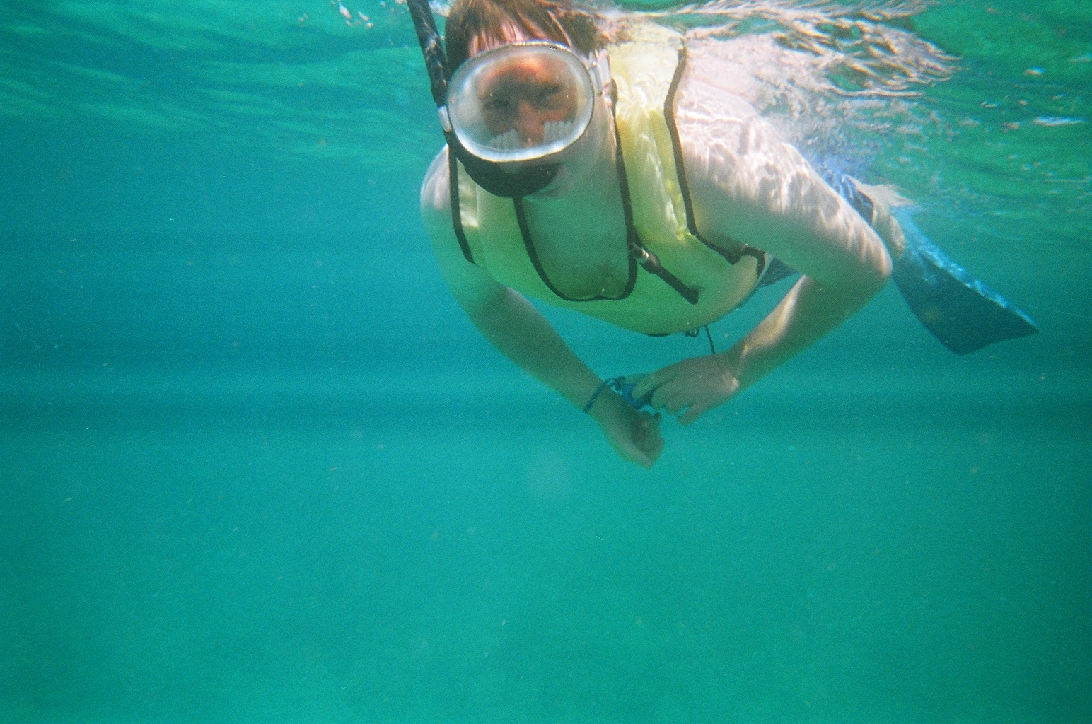 a man floating in the water with a mask and a snorkelet