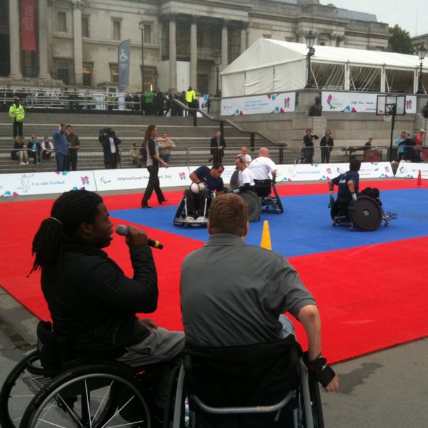 wheelchair - clad man on a red, blue, and green carpet