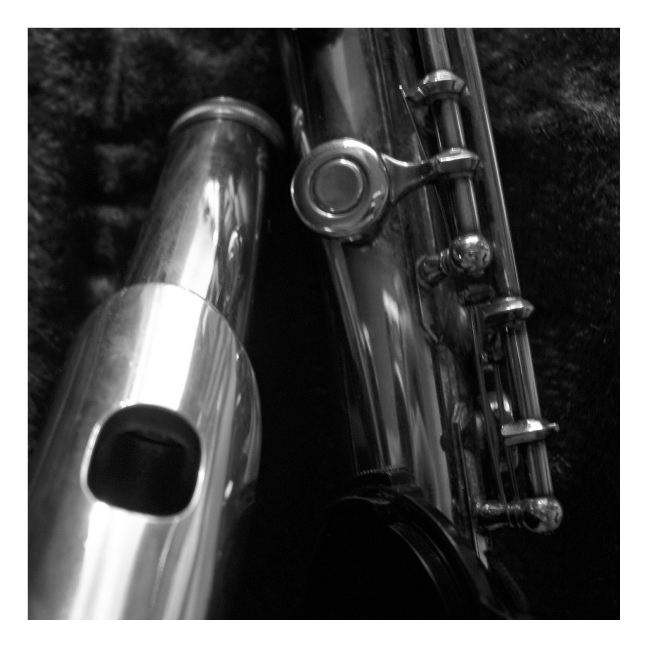 an old silver trumpet is laying beside an older one