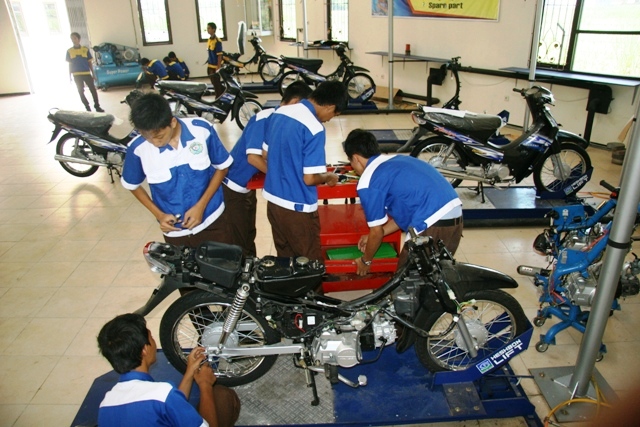 a group of young men looking at some bikes