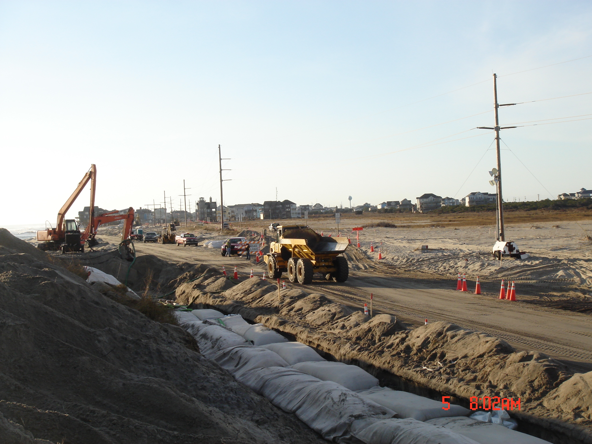 large construction equipment is shown by some sand