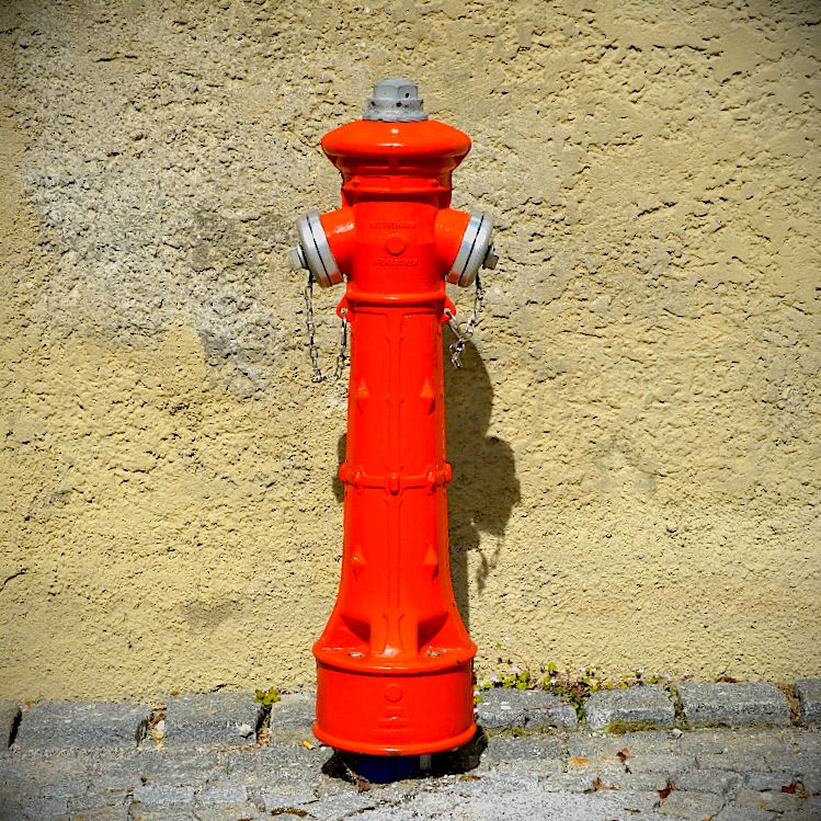 a fire hydrant on a sidewalk next to a building