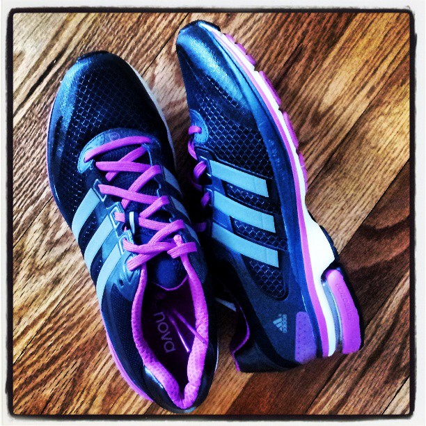 a pair of adidas running shoes, which have purple laces