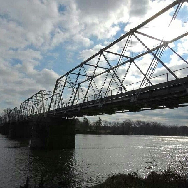 a train is crossing the bridge over a river