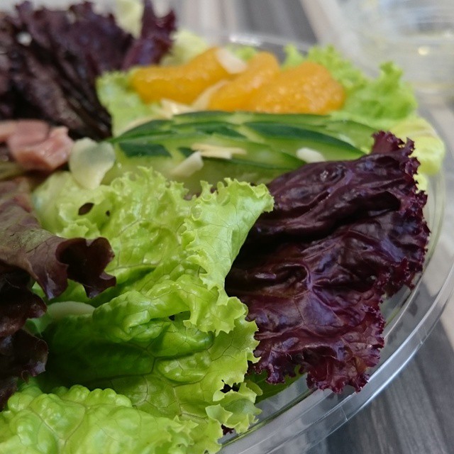 a bowl of lettuce sits on the table