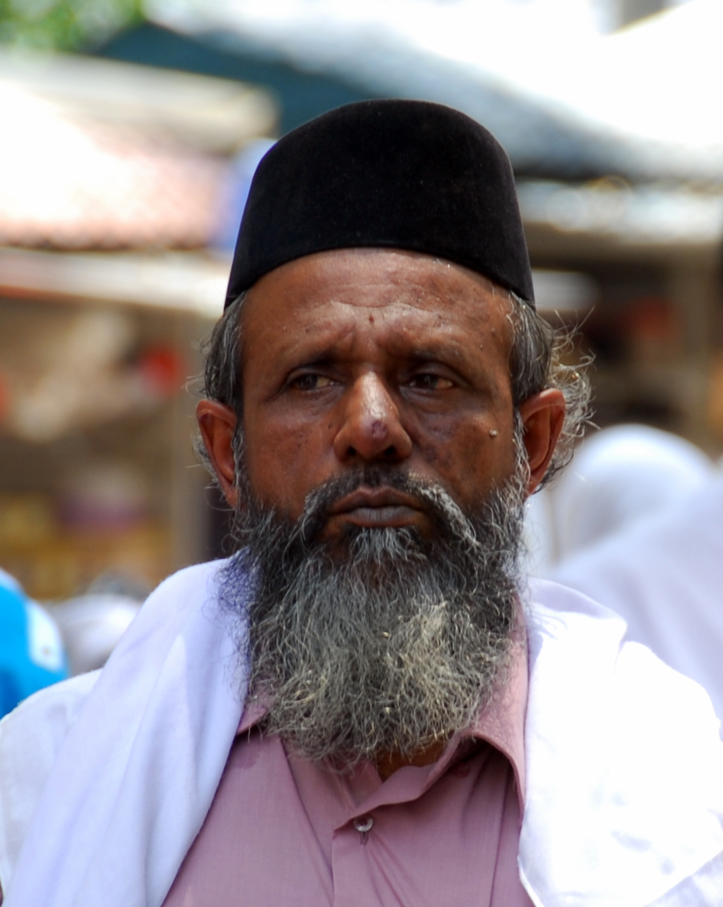 a man with a goatee is looking at the camera