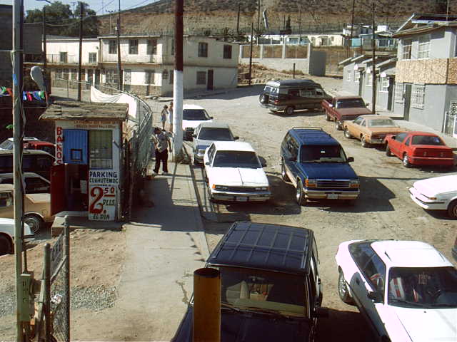 an older town with several cars, trucks, and houses