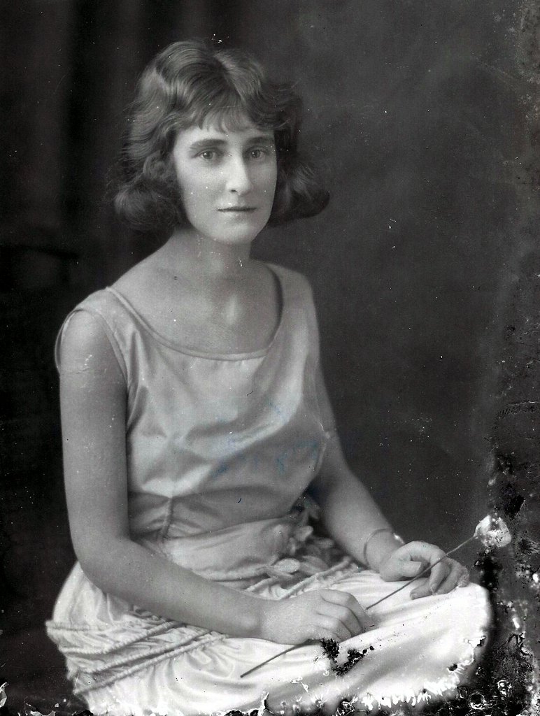a young woman with a short dress is sitting