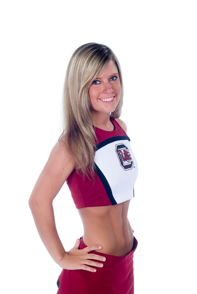 a woman wearing a maroon and white top posing for a po