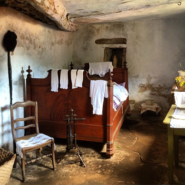 an old fashioned bedroom in an adobe - like house