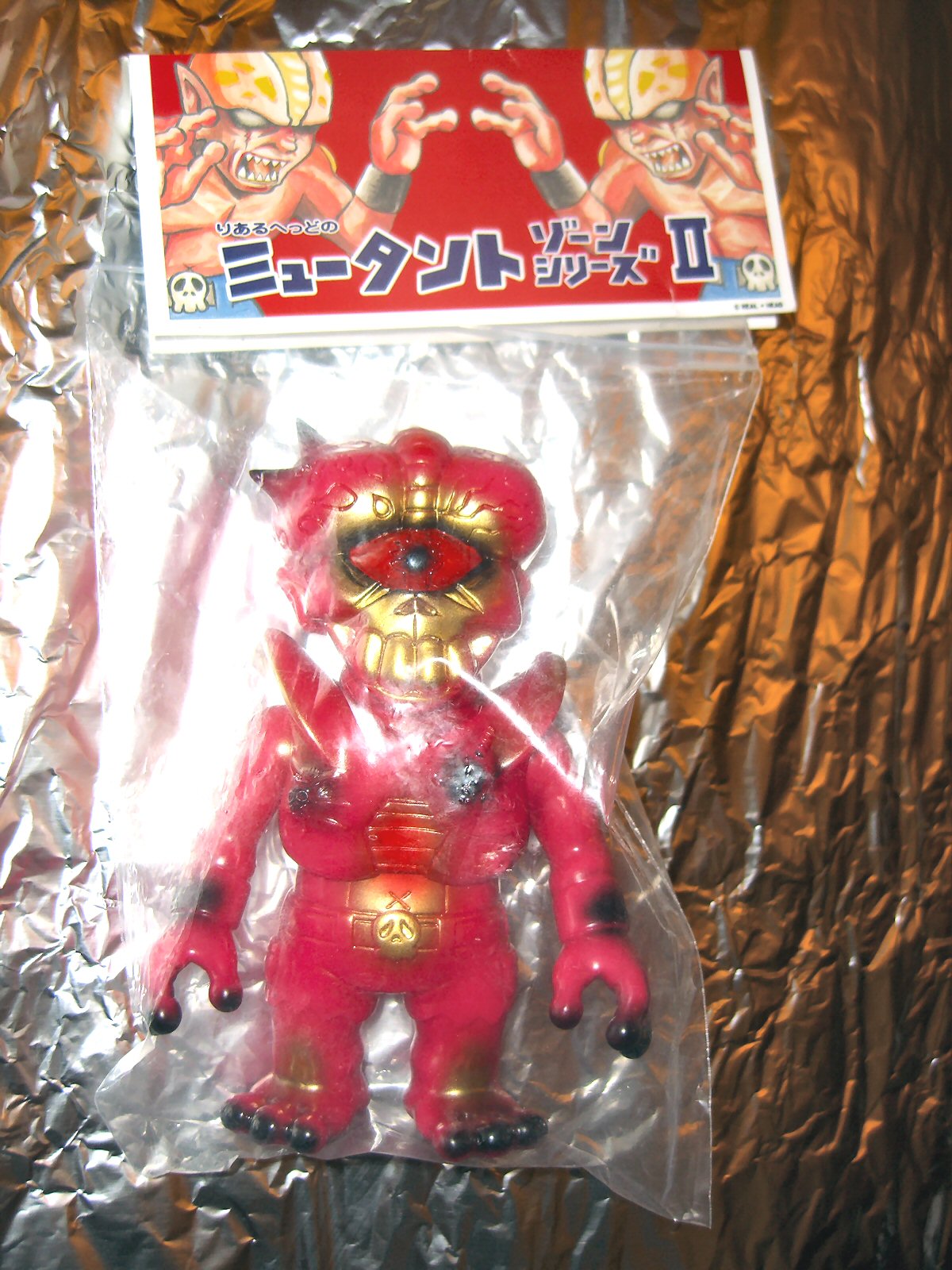 the figure is wearing pink and has large yellow eyes