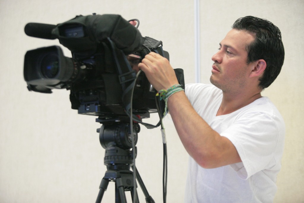 a man who is holding a video camera up