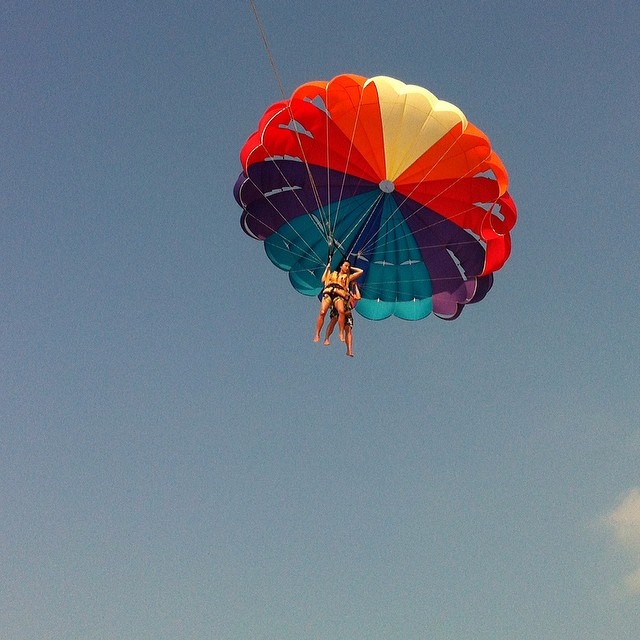 a person is on a parachute and doing tricks