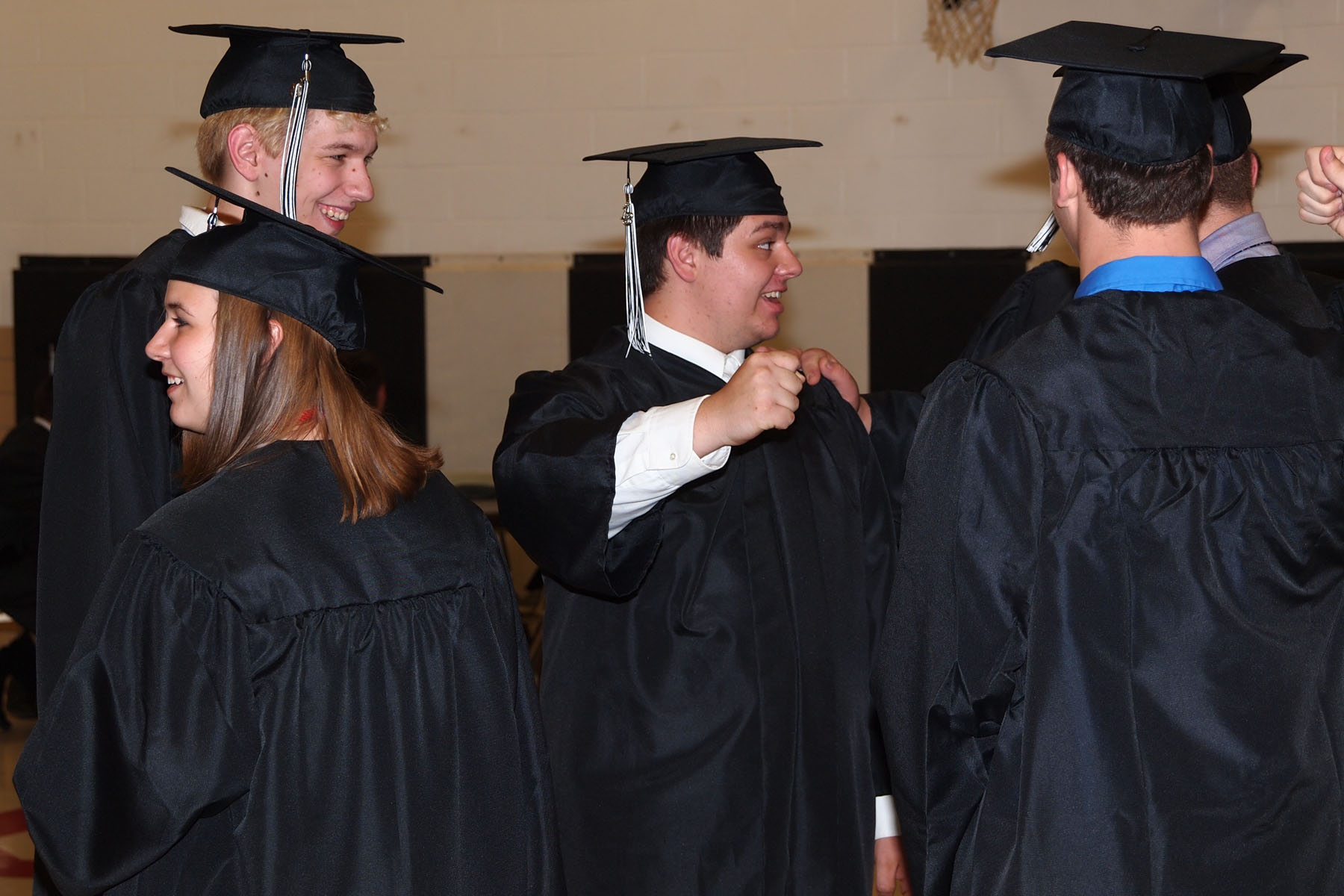 a group of men in graduation gowns stand next to each other