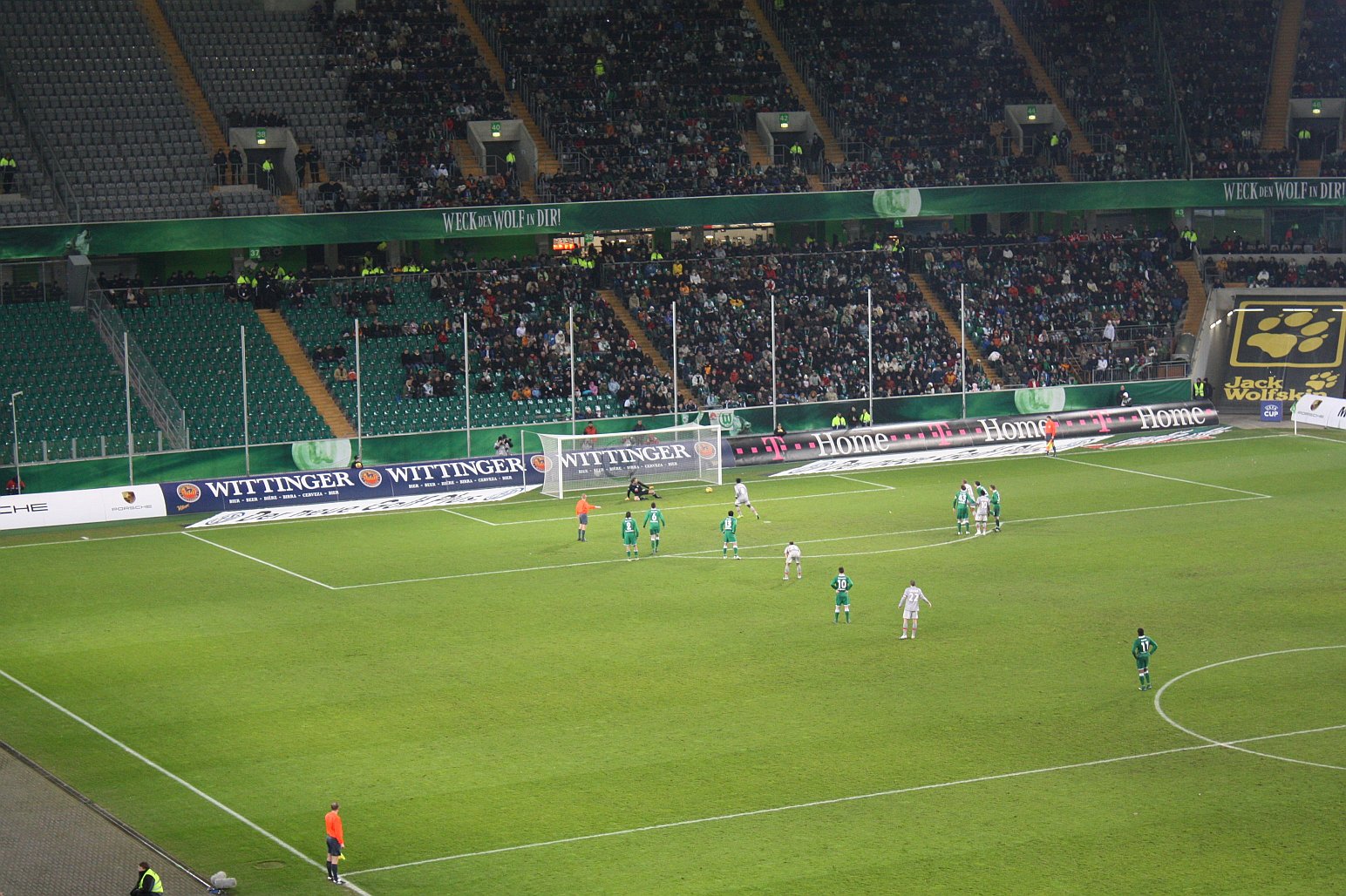 a group of people are playing soccer in a stadium