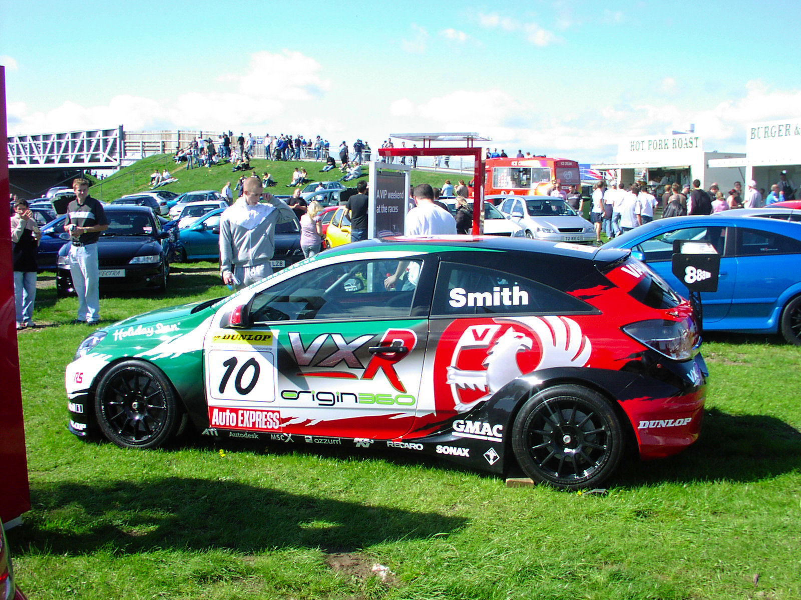 a car with various decals is parked in a park