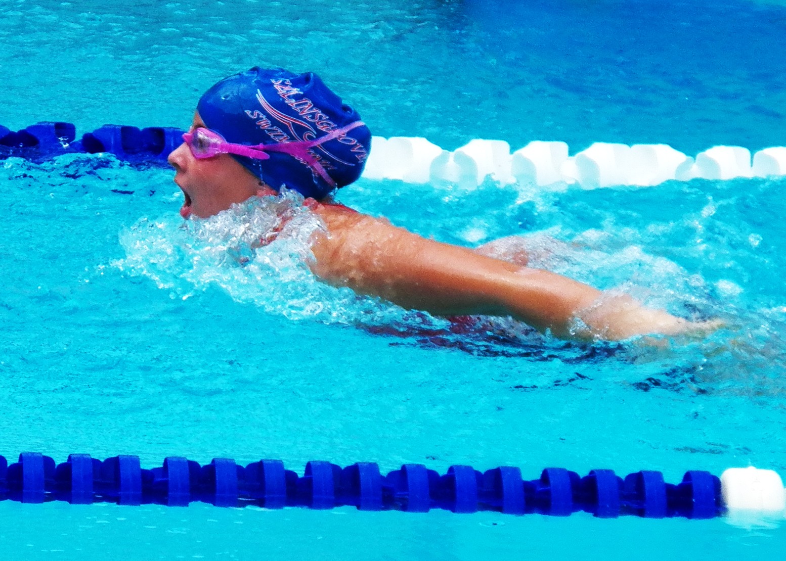 a swimmer in the water with a swimming cap