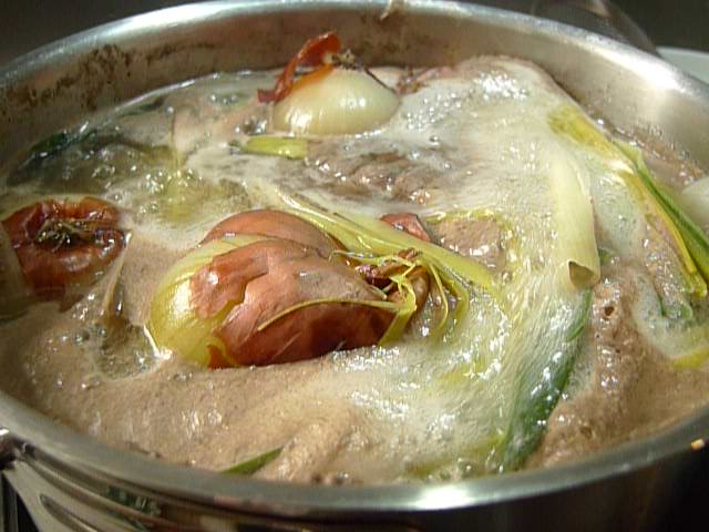 a stew with vegetables simmers in a large pot