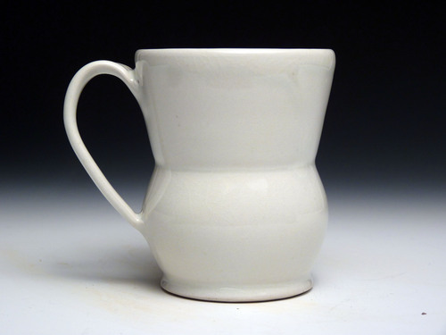 a ceramic pitcher on a white table