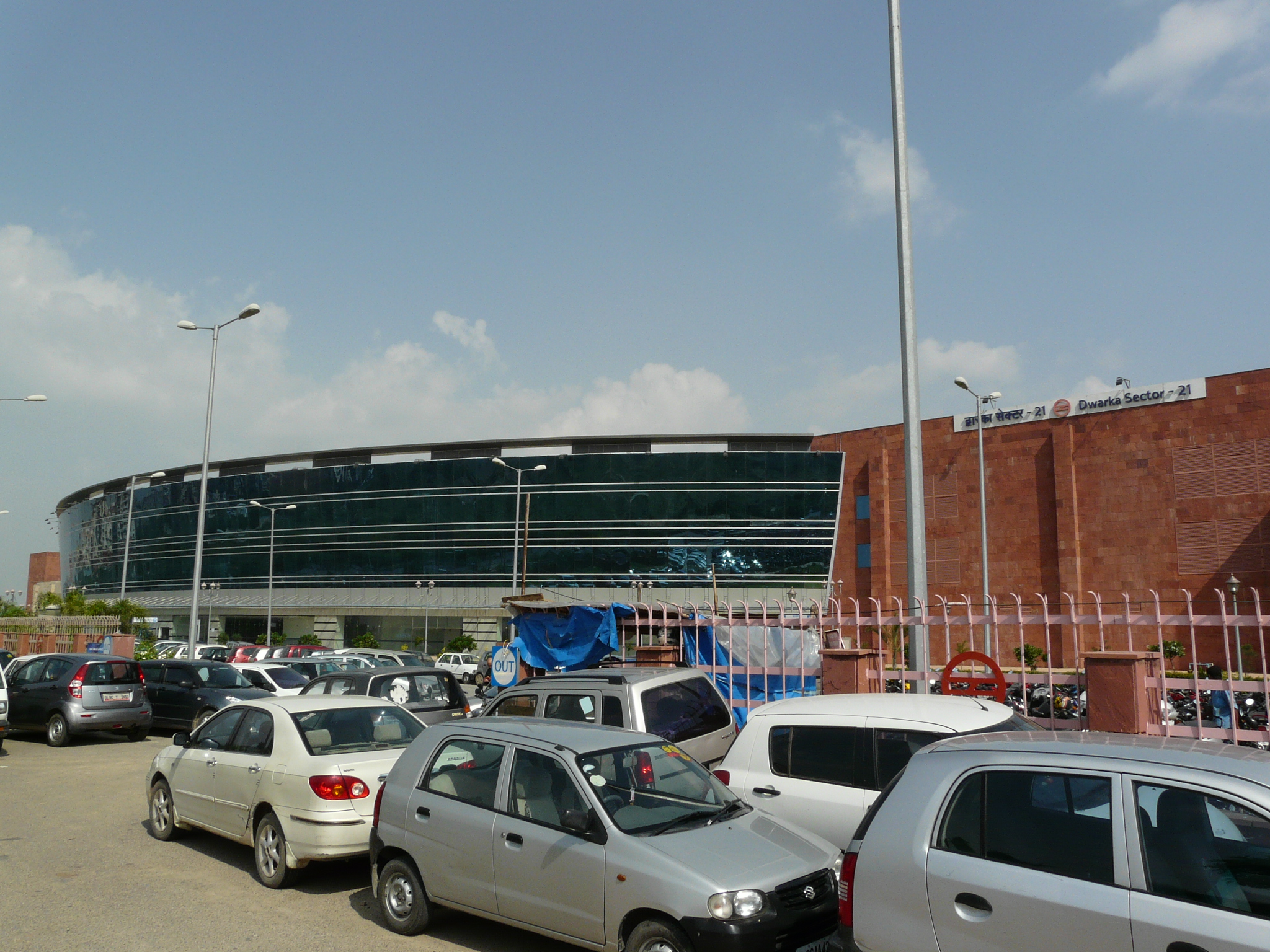 a stadium building with several parked cars in front of it