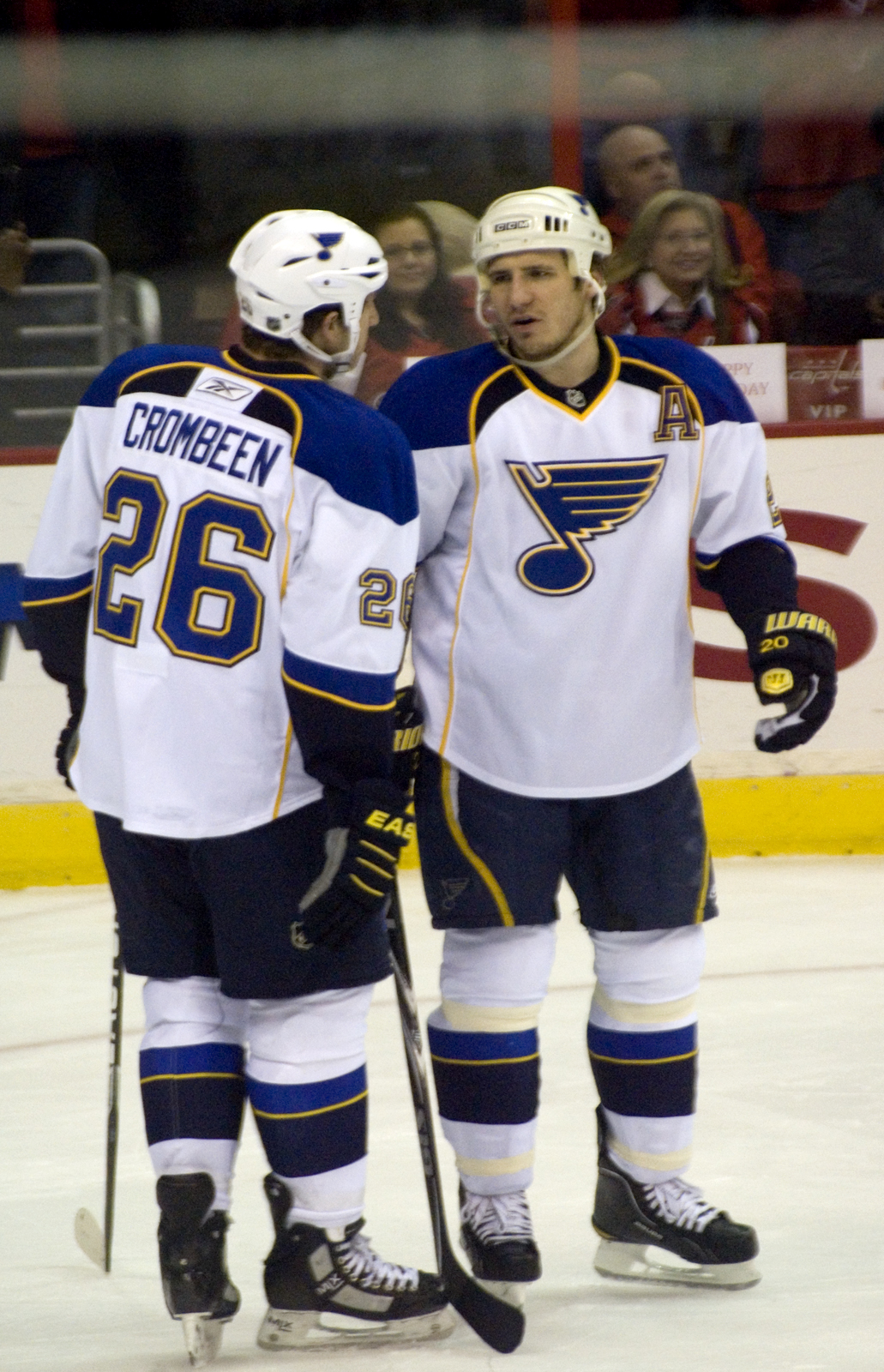 two male hockey players standing together in a rink