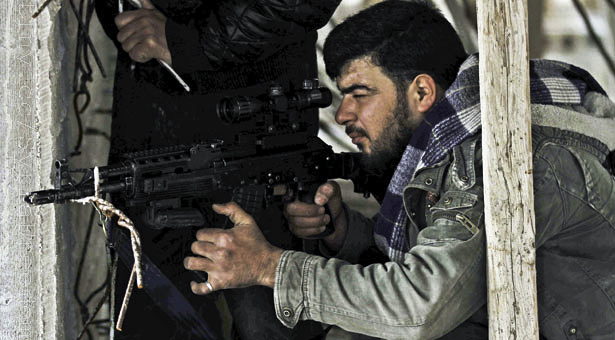 a man is holding an automatic gun in a small shelter