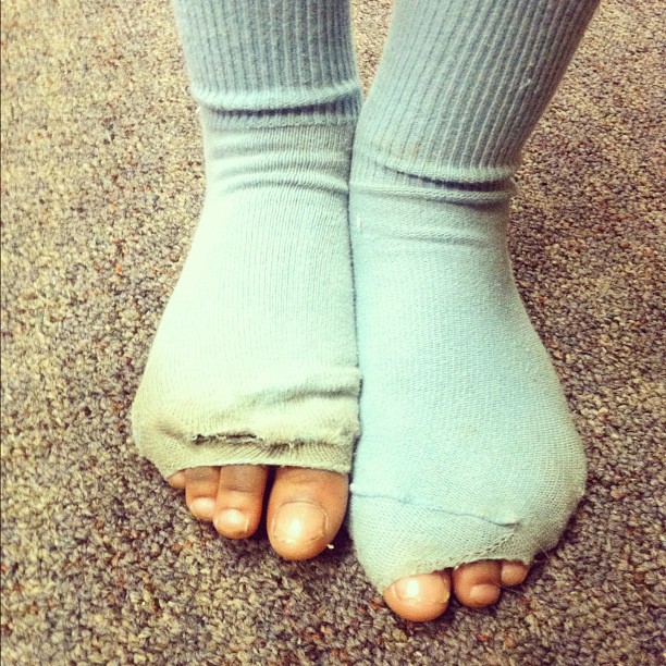 the feet and ankles of a persons feet wearing socks