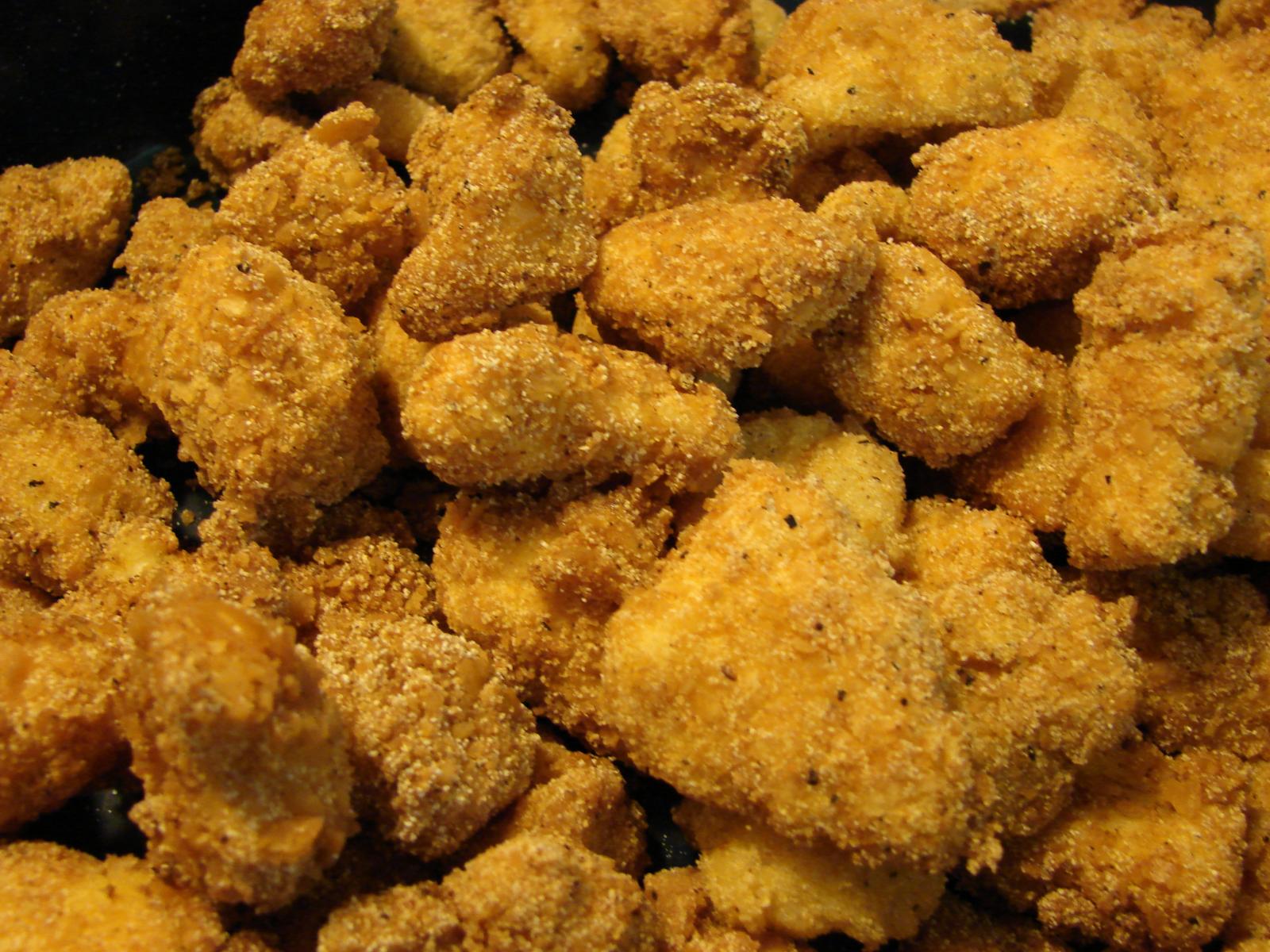 a bunch of fried food being cooked in an oven