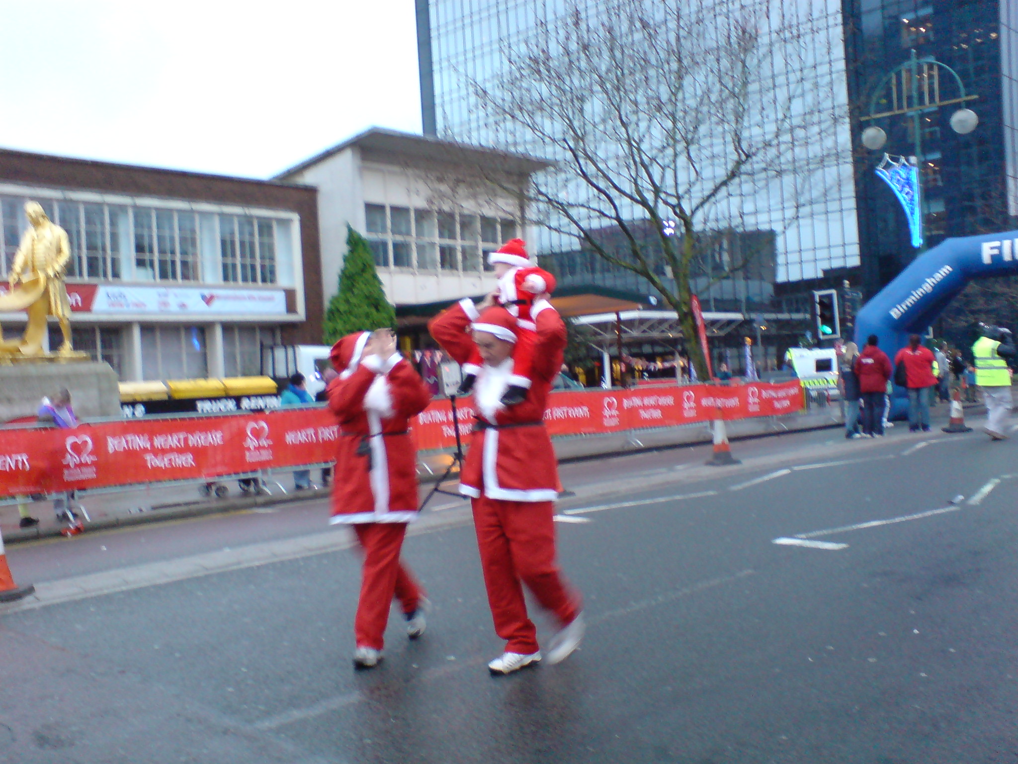 some people in red are dressed up on the street